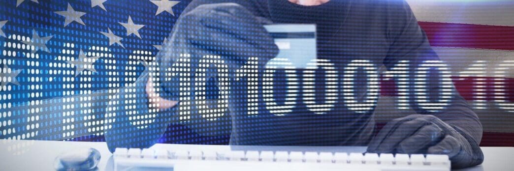 A person is using a laptop and credit card to make an online purchase, with binary code displayed on the screen.