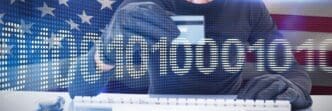 A person is using a laptop and credit card to make an online purchase, with binary code displayed on the screen.