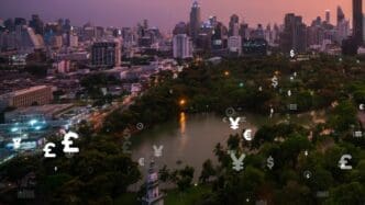 A futuristic interface displays business data analytics over a digital representation of a smart city.
