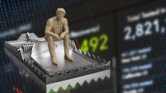 A 3D rendering shows a business man sitting on a trap hovering over a downward-trending chart, representing a financial crisis.