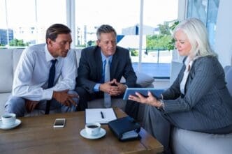 Business people of diverse backgrounds looking at a tablet computer.