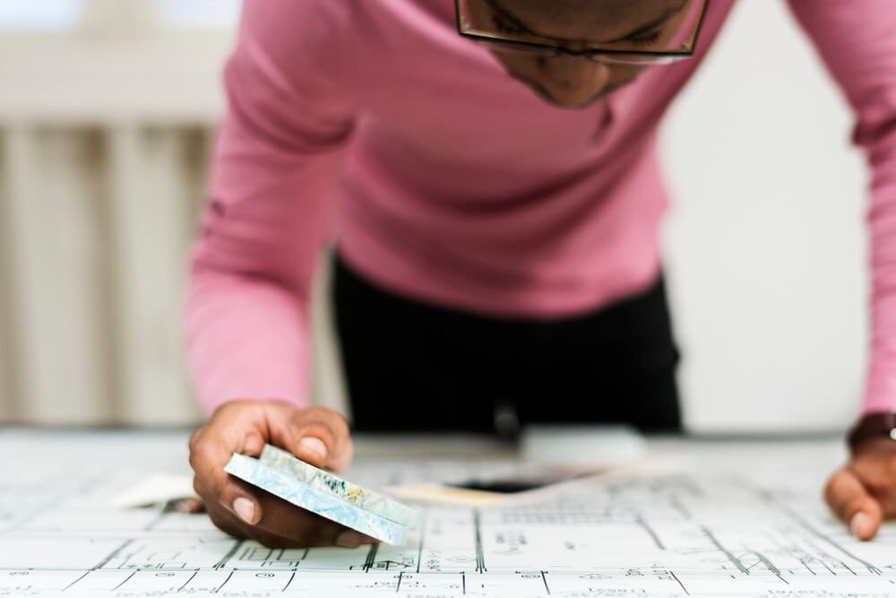 A businessman works at a desk in a modern office setting.