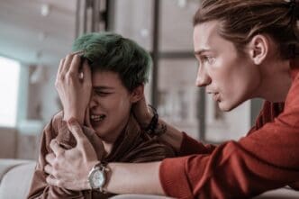 A concerned husband comforts his wife with a bloody nose, offering reassurance.