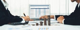 A stack of coins represents business investment, with a shrewd, calculating accountant in the background.