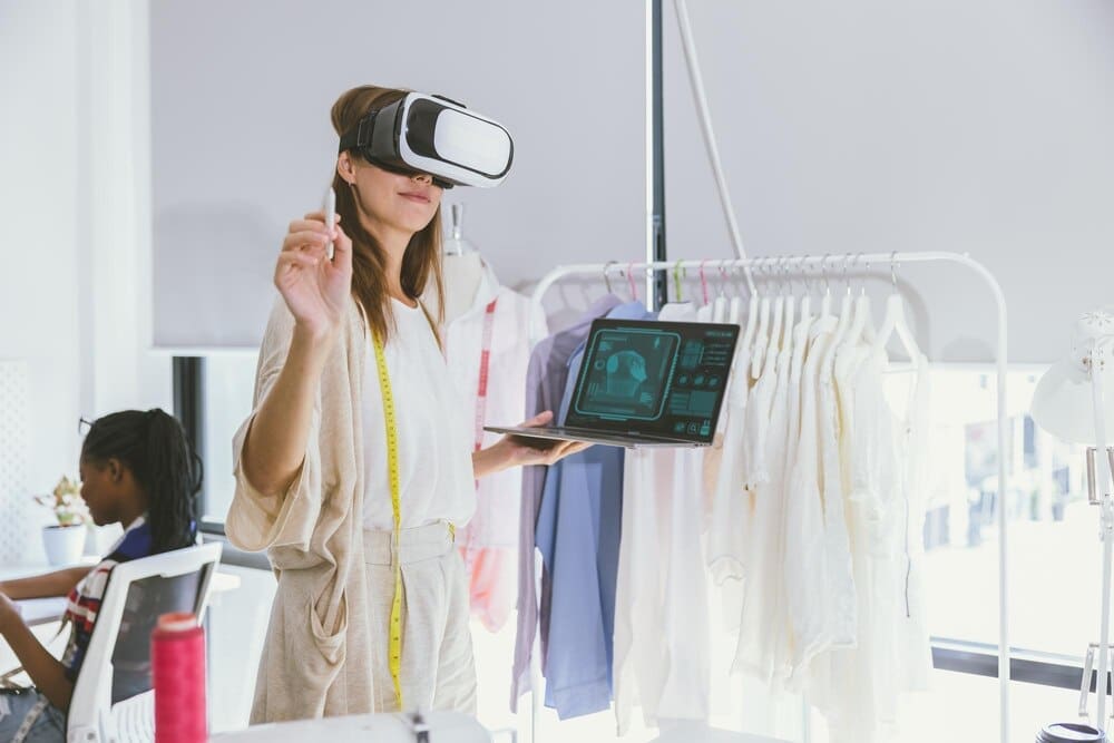 A costume designer uses virtual reality technology to digitally design clothing in a tailor studio.