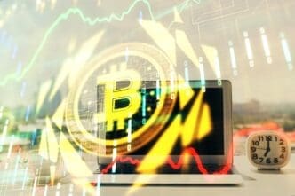 Hologram of blockchain and crypto economy themes superimposed over a table with a computer in the background, representing the concept of Bitcoin cryptocurrency.