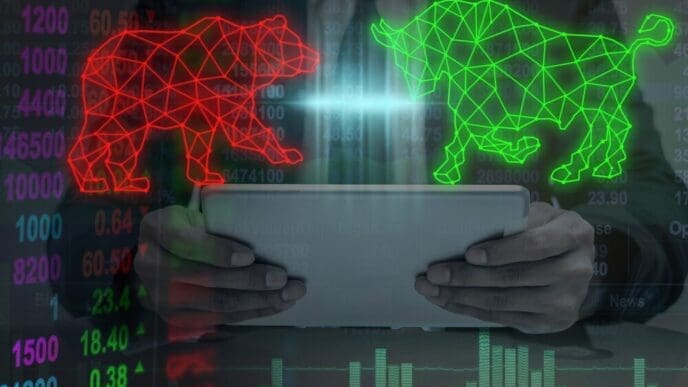 Double exposure of a businessman's hand holding a polygonal bull and bear shape, overlaid with writing.
