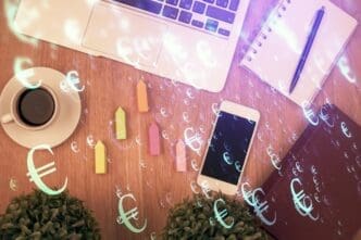 Double exposure showing a financial chart hologram overlaid on a desktop with a phone, representing a mobile trading platform.