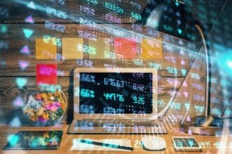 Double exposure shows a forex graph overlaid on a workspace with a computer, representing international online trading.