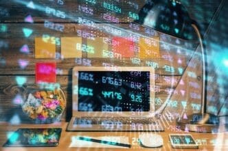 Double exposure shows a forex graph overlaid on a workspace with a computer, representing international online trading.