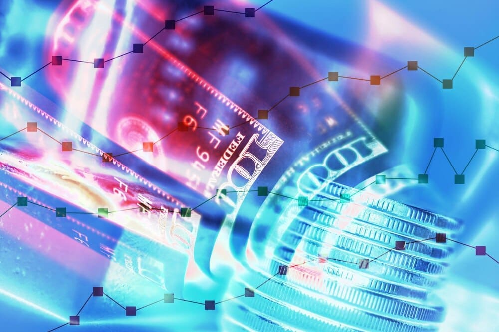Double exposure of a stock market display over rows of gold coins, banknotes, and gold, creating an economy trends background.