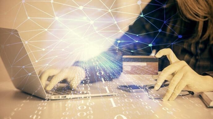 Double exposure shows a woman holding a credit card superimposed with a data-themed hologram related to online shopping.