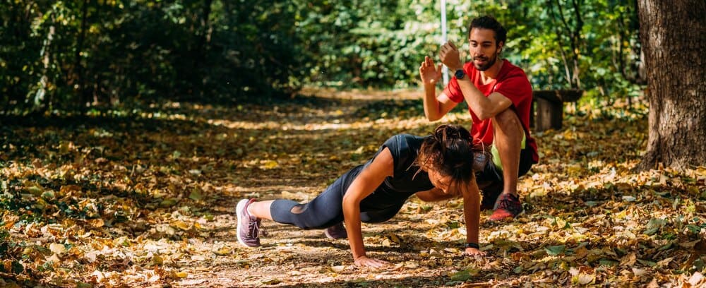 A person is exercising outdoors in a park.