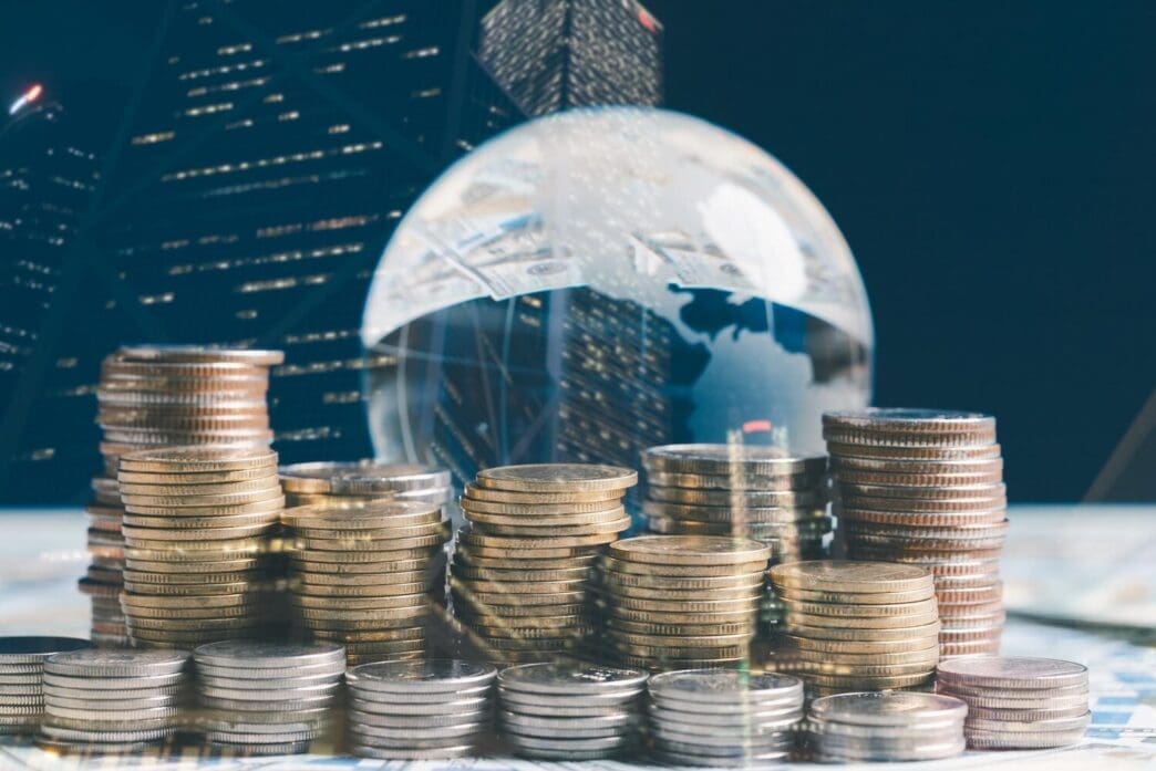 Double exposure of a financial chart and rows of coins, representing investment and business growth.