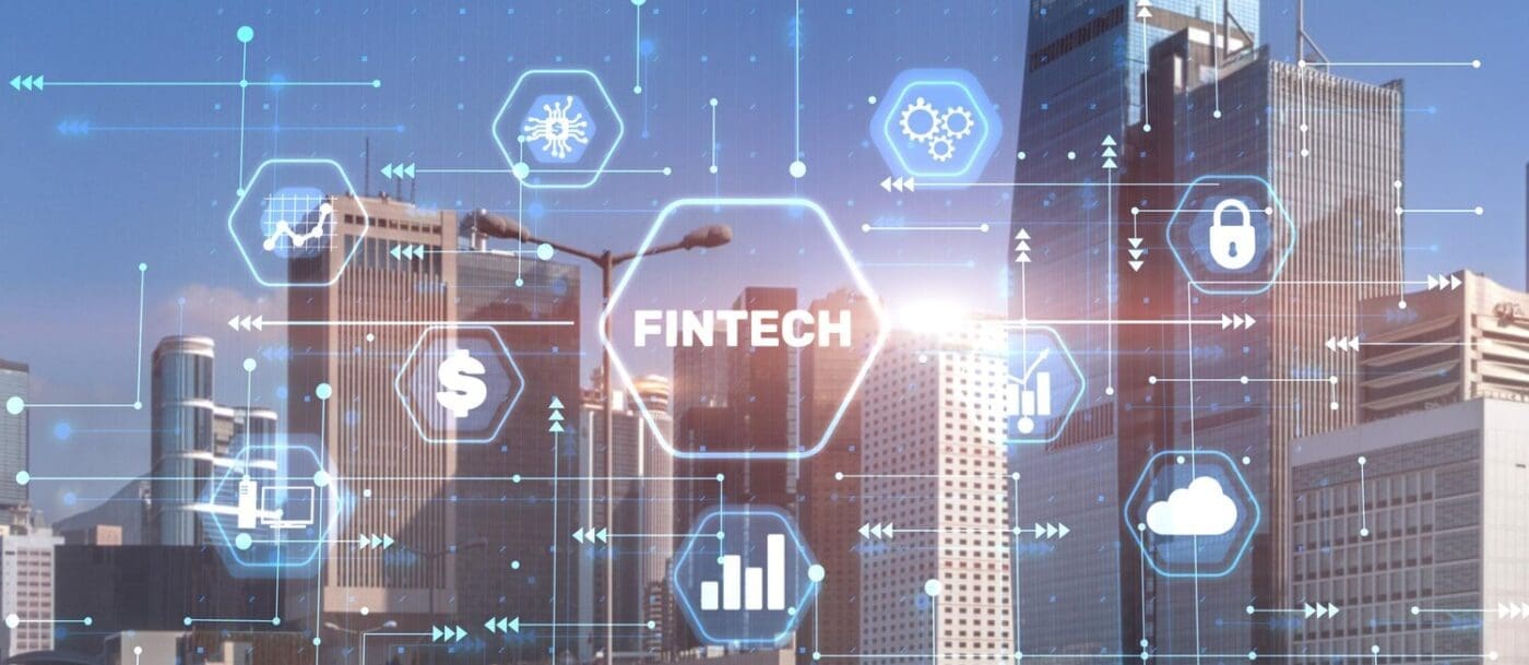 A conceptual image shows the words "Fintech" and "Financial Technology" against a blurry cityscape.