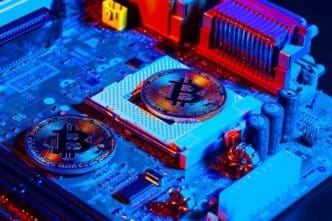 Golden bitcoin and computer chip on a black background.