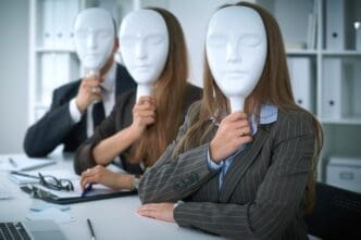 A group of business people sit at a table in a meeting, conveying a negative atmosphere of disagreement or lack of understanding.