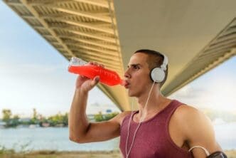 A person takes a drink from a water bottle.