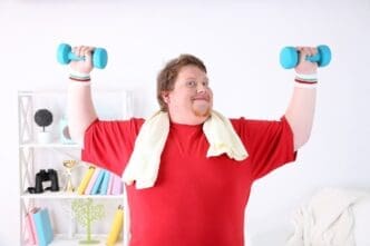 A muscular man lifts weights in his home gym.