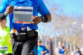 Runners compete in a marathon on a road, representing sport, fitness, and a healthy lifestyle.