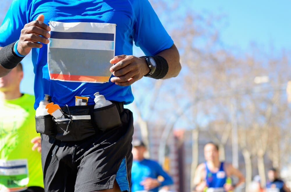 Runners compete in a marathon on a road, representing sport, fitness, and a healthy lifestyle.