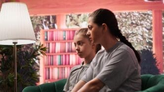 A mother and teenage daughter are seated in a therapist's office, likely engaged in a therapy session.