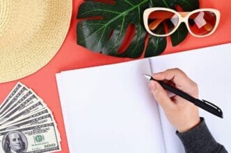 Notebook on a coral background, suggesting preparation for a summer vacation.