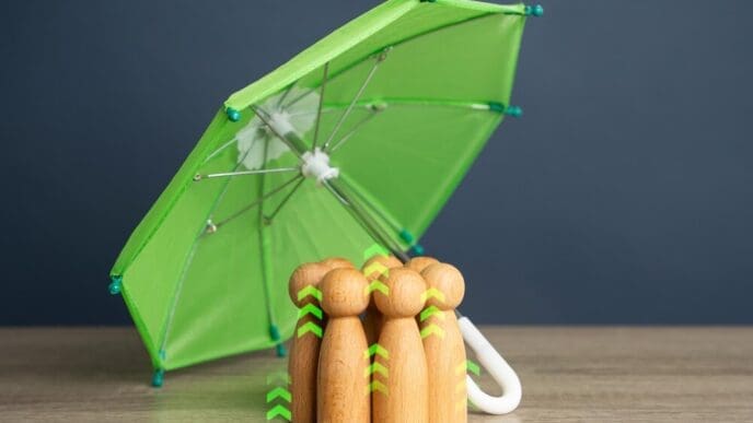 People sheltering under an umbrella.