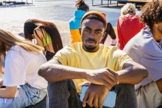 Close-up of a group of friends with hands clasped together.