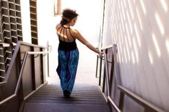 Rear view of a woman descending a flight of stairs.