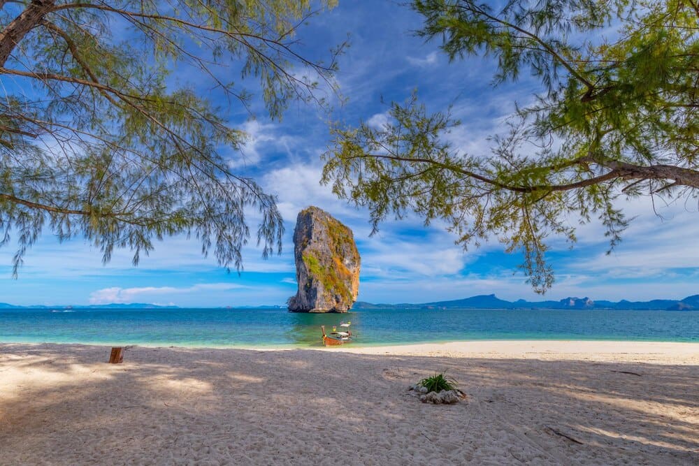 A vast seascape features a calm ocean meeting a clear sky at the horizon.