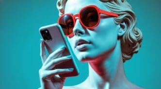 A woman wearing red sunglasses holds a smartphone while posing in front of a sculpture.