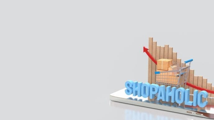 A 3D rendering depicts a shopping cart and a box, symbolizing the shopaholic concept on a mobile device.