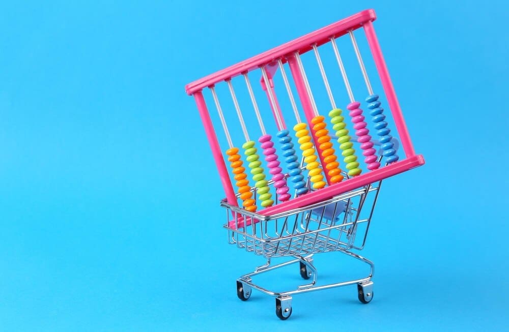 A shopping cart icon with an abacus inside sits on a light blue background.