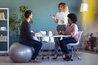 Young businesspeople collaborate on a new project in a casual office setting.