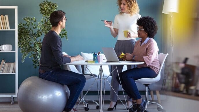 Young businesspeople collaborate on a new project in a casual office setting.