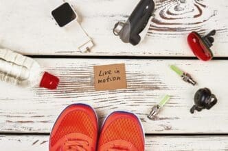 A pair of sneakers, a smartwatch, and a water bottle are displayed.