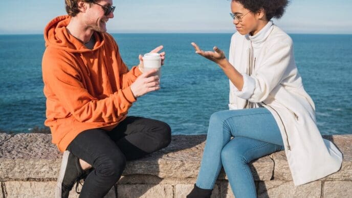 Two friends laughing and smiling while enjoying an activity together.
