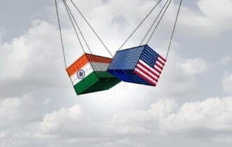 A graphic depicts the USA and India engaged in a trade war, illustrating an economic conflict over tariffs and trade relationships.