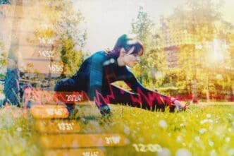 A woman stretches outdoors on a sunny day, likely at a gym or park.