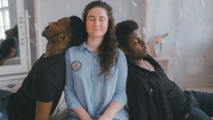 A young woman stands among a group of young men.