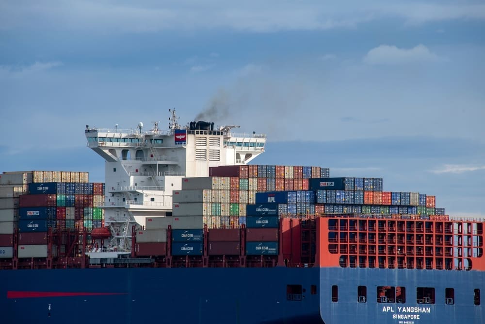 The APL Yangshan cargo ship, fully loaded with colorful containers, sails through the Strait of Juan de Fuca