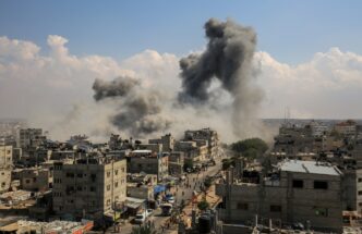 Plumes of dark smoke rise over the city of Rafah in the Gaza Strip after an Israeli airstrike