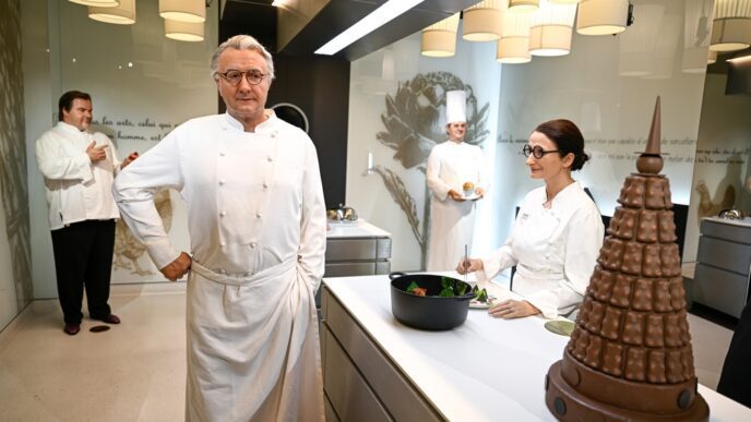 The wax statue of French chef Alain Ducasse stands in a museum kitchen exhibit