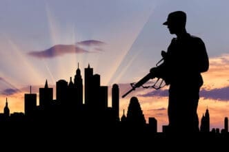 An artistic rendering of military weapon silhouettes set against a US city at dusk, evoking a sense of war and crisis.
