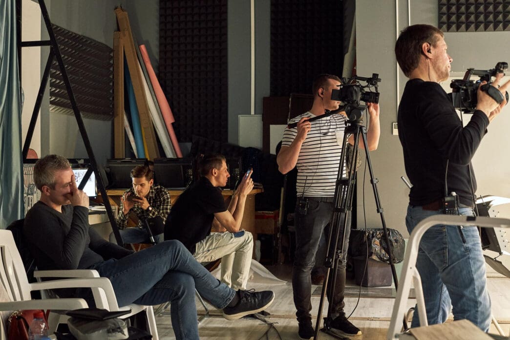 Filmmakers are busy with their equipment on the set