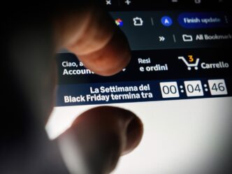 A person's finger hovers over a laptop screen with a Black Friday countdown timer