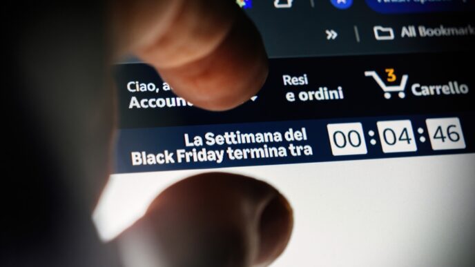 A person's finger hovers over a laptop screen with a Black Friday countdown timer