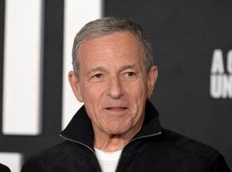 Bob Iger, the CEO of The Walt Disney Company, smiles for a photo at a film premiere