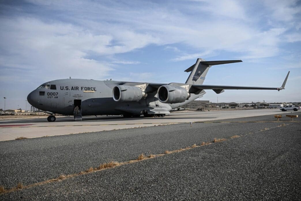A Boeing C-17 Globemaster III military transport aircraft is parked on an airfield.